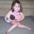 Little girl nursing dolls
