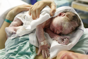 mother-hugging-a-vernix-covered-newborn