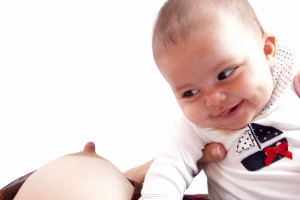 baby looking at the mother's breast